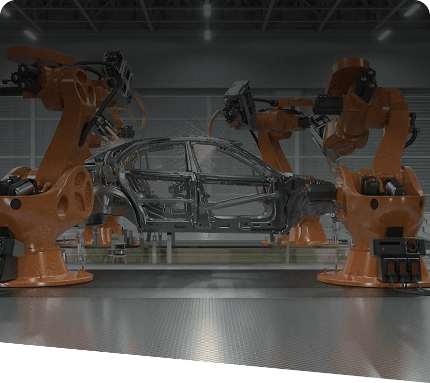 Robotic arms assembling a car chassis in an automobile manufacturing plant