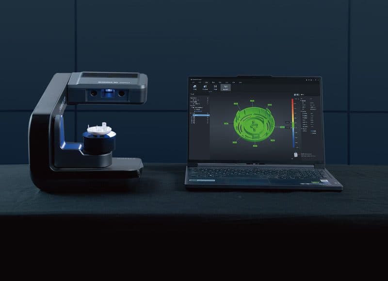 AutoScan Inspec2 desktop 3D scanner beside a laptop showing a scanned part