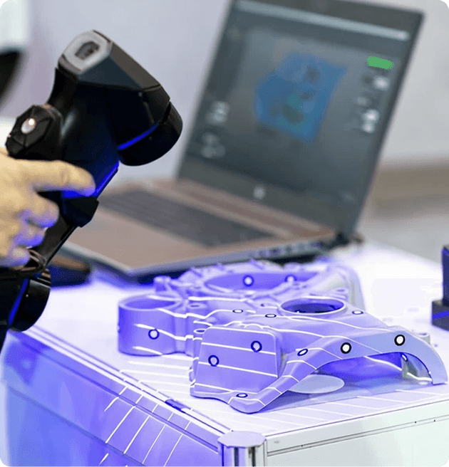 Technician using a handheld laser tracker scanner